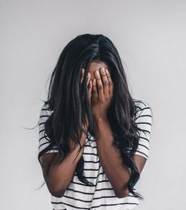 A woman holds her head and cries - image from Burst by Shopify