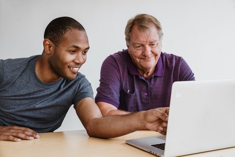 Young man teaches older man