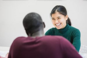 A woman smiles after meeting a new friend