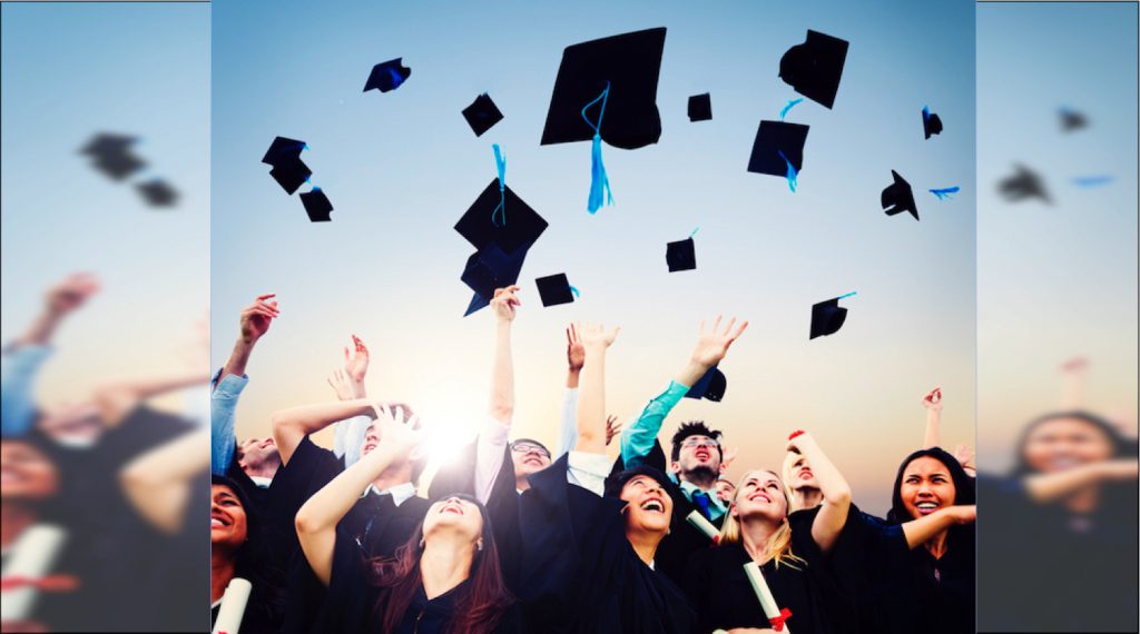 Graduates throw their caps in the air