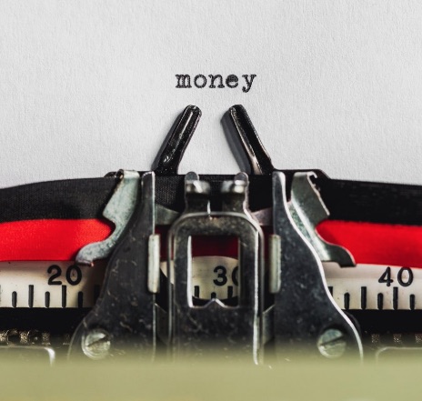 The word money typed on paper from Burst by Shopify