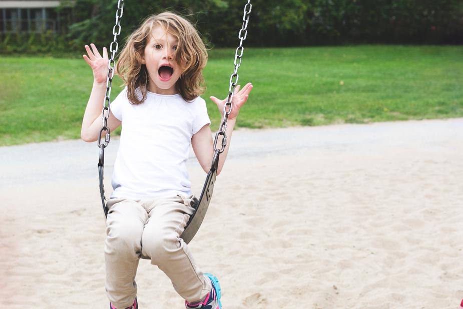 Girl plays on swing